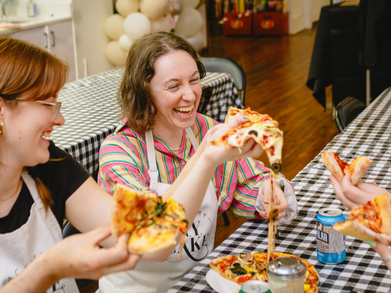 Women enjoying their handmade pizza